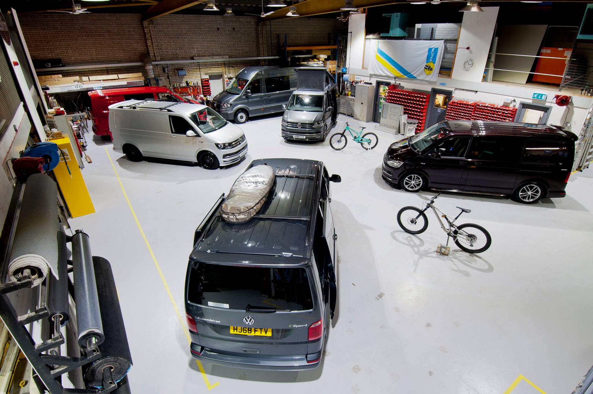 Six Volkswagen vans in the Flexivan workshop