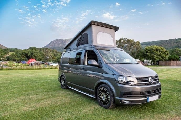 Grey Volkswagen camper conversion with open sky pop-top roof